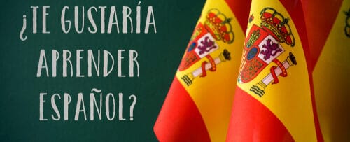 「tu gustaria aprendir espanol?」という言葉が書かれた 2 つのスペイン国旗。