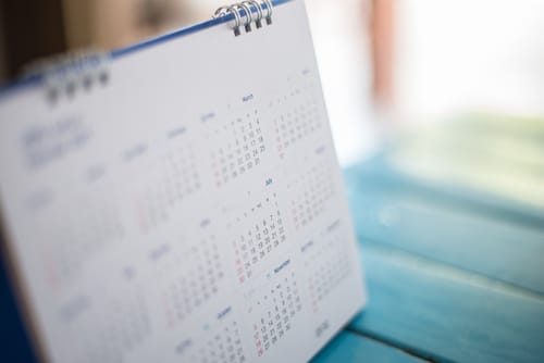 木製のテーブルの上に置かれたスペインのカレンダー。