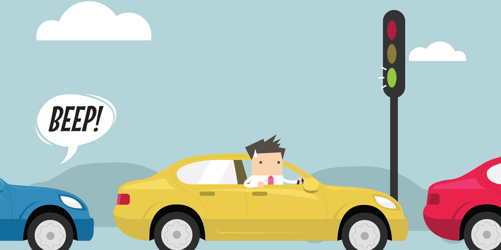 スペインで信号で車を運転する男性の漫画。