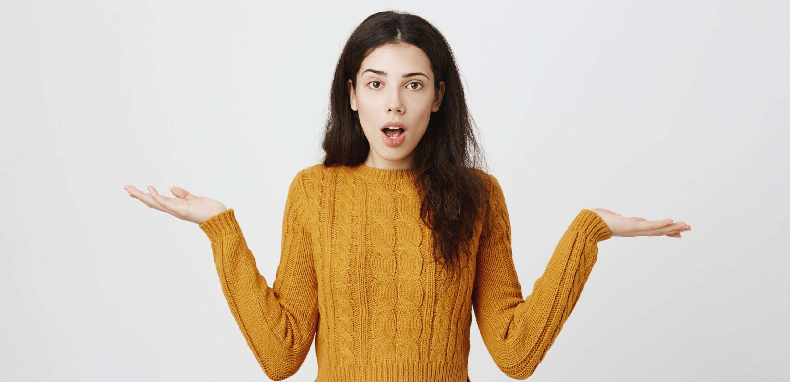 黄色いセーターを着て手を広げている女性。