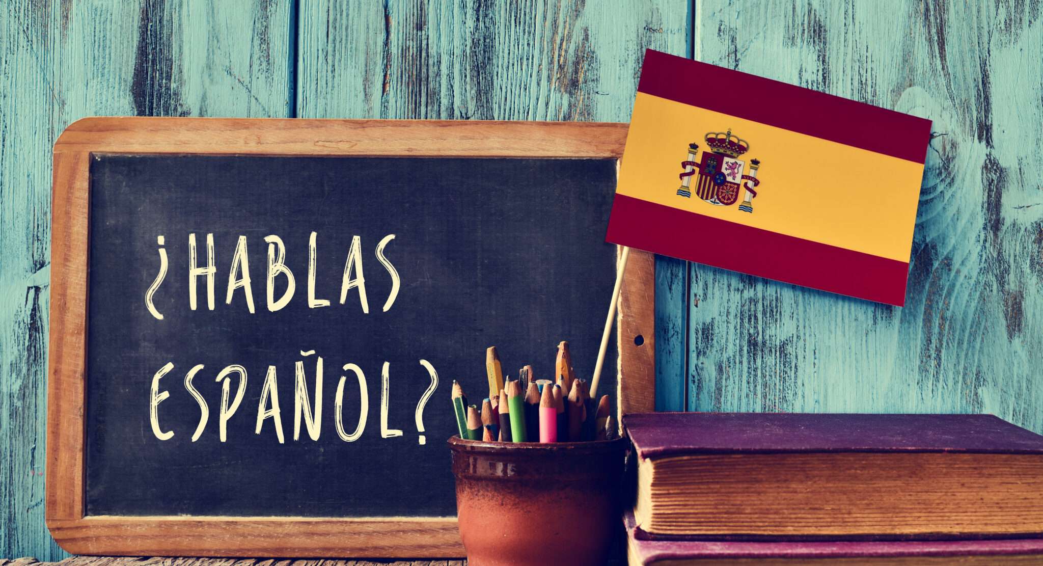 「hablas español」という言葉とスペインを表すスペイン国旗が描かれた黒板。